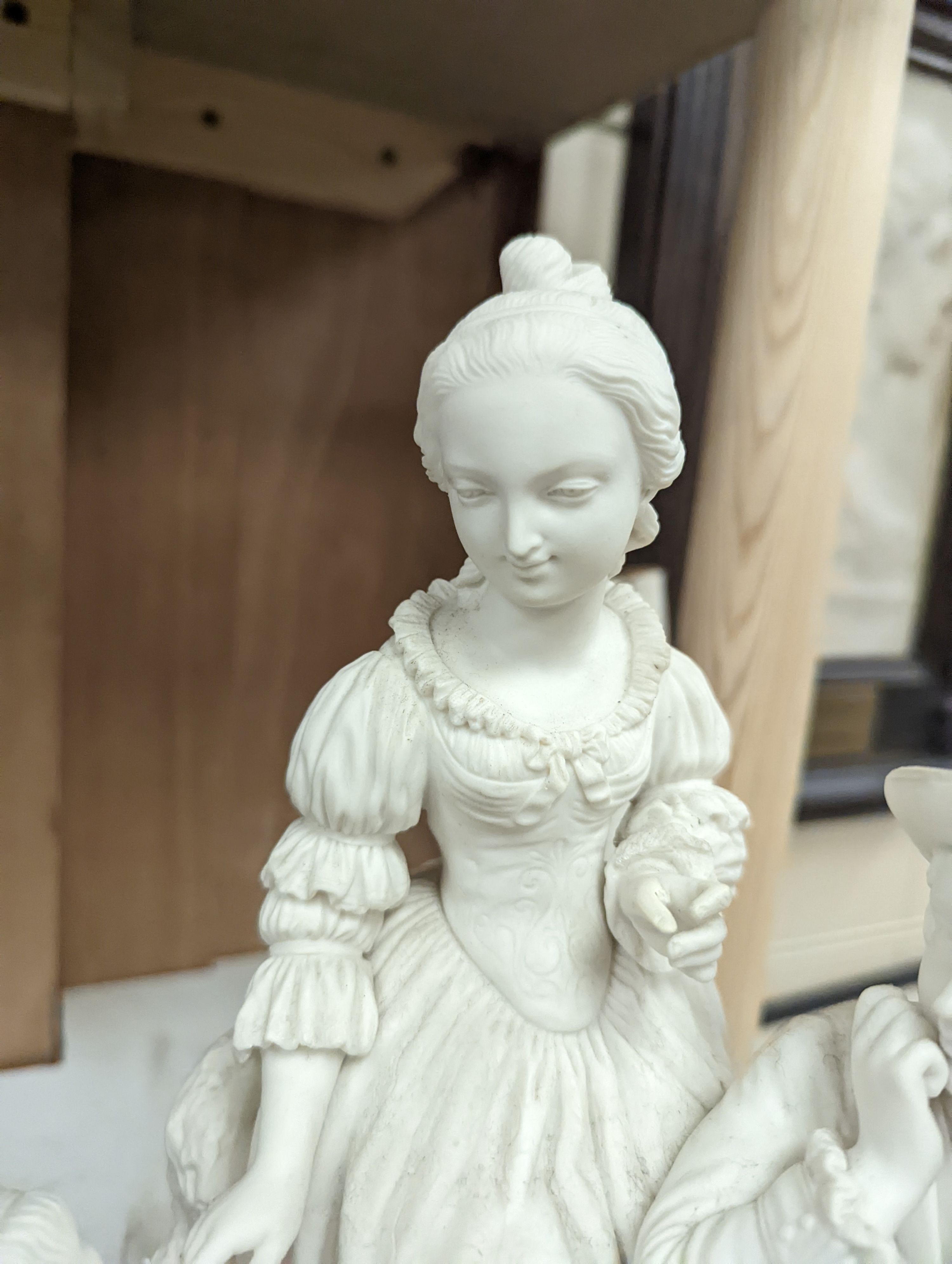 A 19th century Adams & Co. parian group of a man, woman, child and dog 31cm